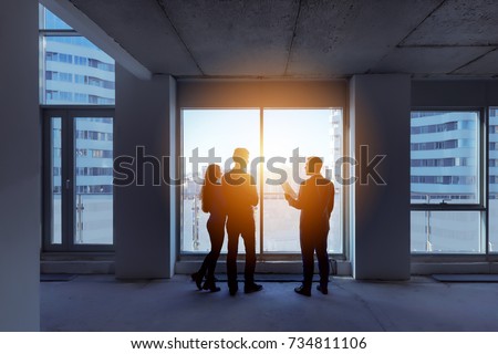 Real estate concept with agent and couple near big panoramic window