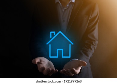 Real estate concept, businessman holding a house icon.House on Hand.Property insurance and security concept. Protecting gesture of man and symbol of house - Powered by Shutterstock