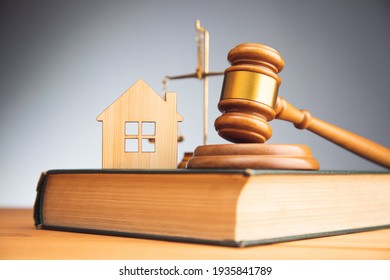 real estate concept. House model, gavel and law books