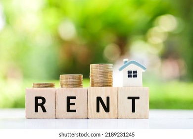 Real estate concept. House for rent. house model and stack of coin. Payment for temporary use of a property owned by another owner, tenant unwilling to pay full price, avoid burden of upkeep.