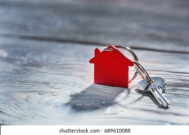 Real Estate Concept, Key Ring And Keys On Wooden Background