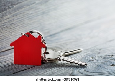 Real Estate Concept, Key Ring And Keys On Wooden Background