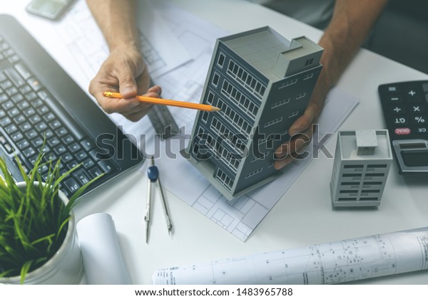 real estate development - construction\
engineer working on new house project in\
office