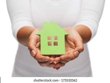 real estate and eco concept - closeup picture of woman hands holding green house - Powered by Shutterstock