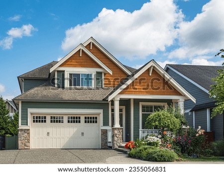Real Estate Exterior Front House on a sunny day. Big custom made luxury house with nicely landscaped front yard and driveway to garage in suburbs. Modern designed home, New construction home exterior