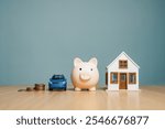 real estate, estate, finances, insurance, invest, management, mortgage, planning, profit, property. A blue car is on a table next to a piggy bank and a house.