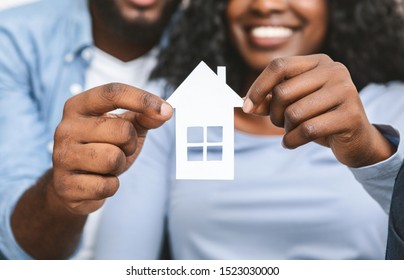 Real Estate, Housing And Family Concept. Close Up Of Black Couple Holding Wooden House