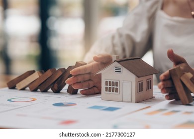 Real estate and insurance concept. Agent using hand symbol to protect risk might happen to house - Shutterstock ID 2177300127