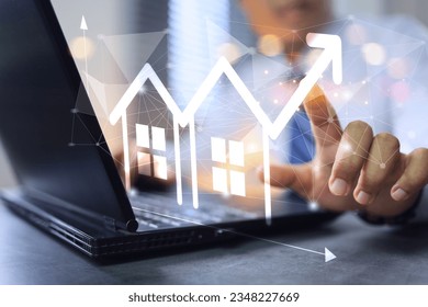 Real estate investment, investor buy a house land location. Investor work on laptop computer to invest real estate in office click on increase graph arrow. Facility management concept.