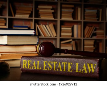 Real Estate Law Book And Gavel On It.