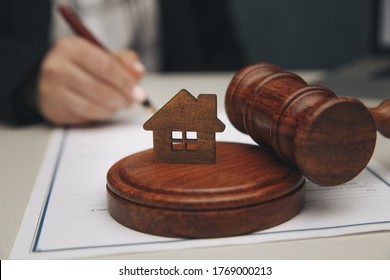 Real Estate Law concept. Model of house and a gavel.