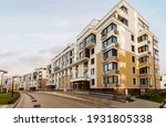 Real estate low rise construction building exterior in new residential area for sale blue sky sunny background. Urban development concept image