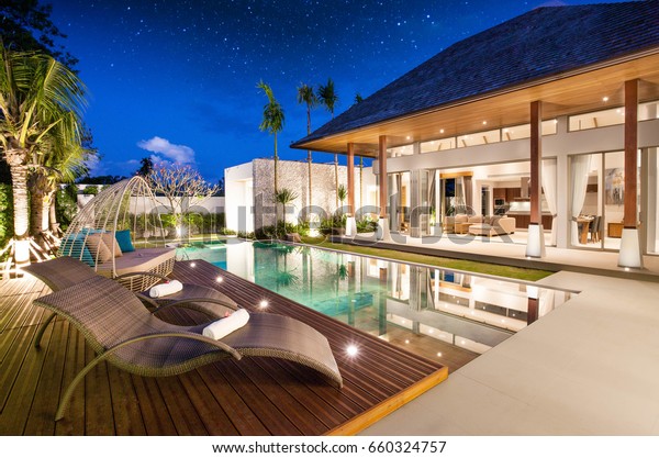 real\
estate Luxury Interior and exterior design  pool villa with living\
room  at  night sky  home, house ,sun bed\
,sofa