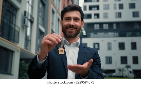 Real estate manager homeowner businessman banker salesman caucasian successful man sell house property hold keys from new apartment in city modern building construction sale commercial business deal - Shutterstock ID 2229594871