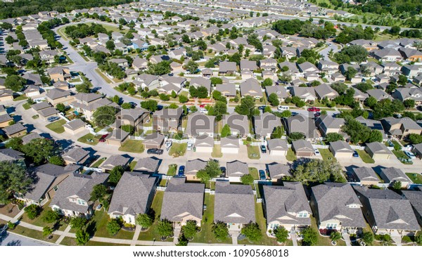 Real\
Estate New Development aerial drone view never ending rows of homes\
and houses square cookie cutter suburb suburbia neighborhood North\
of Austin in Round Rock , Texas , USA drone\
view