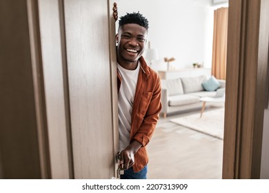 Real Estate Offer. African American Male Opening Door Of His New House Smiling To Camera And Welcoming You To Apartment. Welcome To My Home. Property Purchase Concept