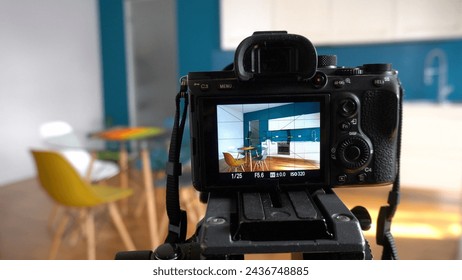 Real estate photographer taking pictures and videos  at house  in apartment living room with professional camera - selling home with real estate agency and home staging indoor home design  - Powered by Shutterstock