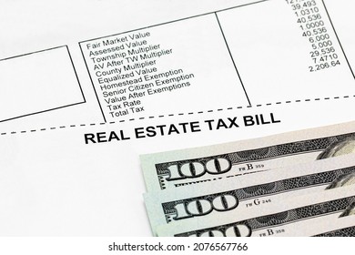 Real Estate Property Tax Bill With 100 Dollar Bills. School Funding, Taxes, Debt, And Local Government Funding Concept