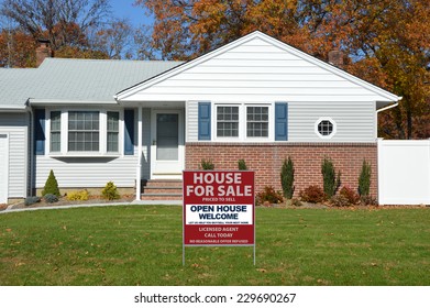 Real Estate For Sale Open House Welcome Sign On Front Yard Lawn Of Suburban Home Fall Day Residential Neighborhood USA Blue Sky