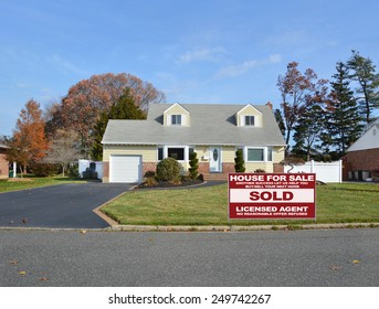 Real Estate Sold (another Success Let Us Help You Buy Sell Your Next Home) Sign Suburban Cape Cod Home Autumn Blue Sky Day Residential Neighborhood USA