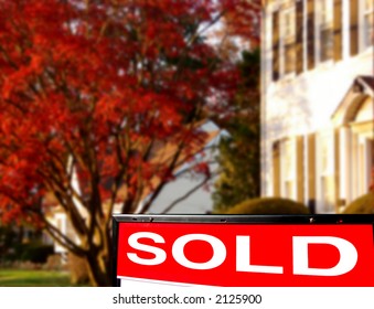 Real Estate Sold Insert Rider On Realtor Lawn Sign With White Colonial Style House For Sale