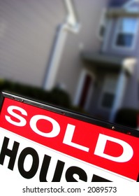 Real Estate Sold Rider Insert On A Realtor Advertising Sign In Front Of A House For Sale