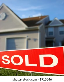 Real Estate Sold Sign Rider On Realtor Advertising Sign In Front Of A House For Sale