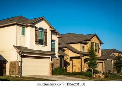 Real Estate Suburb Development In Austin Texas Evening Afternoon Sunset Bright Sunshine On Front Yards And Facade Of New Homes In Central Texas