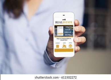 Real Estate Website In A Mobile Phone Screen. Woman Holding Phone In The Hand. Website Template Design  Specifically Designed And Released.