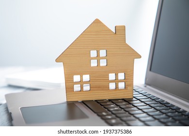 Real Estate, Wooden House Model On Computer Laptop
