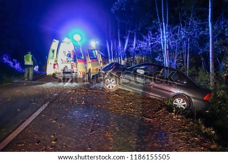 Real event. Car accident. The car crashed at night on a wet road . Car accident over raining day in autumn time. Rescuers help with car accident, ambulance, fire and police.