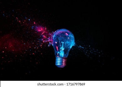 real explosion of a tungsten filament bulb. high speed photography. black background. concept of obsolete energy, crisis, fragility.