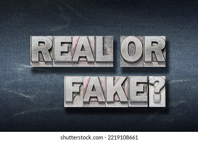real or fake question made from metallic letterpress on dark jeans background - Shutterstock ID 2219108661