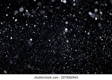 Real falling snow on black background for blending modes in ps. Ver 05 - many snowflakes in blur. - Shutterstock ID 2073060965