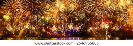 Real fireworks background. Firework Display, abstract blur of real golden shining fireworks lights at night sky. glowing fireworks show. Firework Explosive Material. New year's eve fireworks	