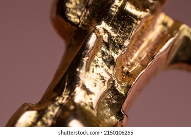 Real Golden Piece Of Jewellery With A Irregular Shiny Surface, Detail Shot Of A Yellow Gold Nugget