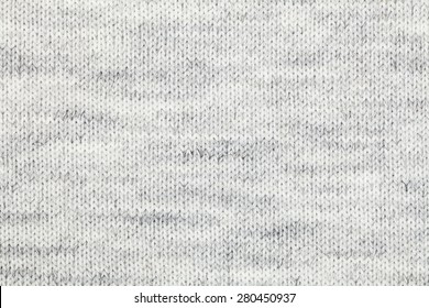 Real grey knitted fabric made of heathered yarn textured background