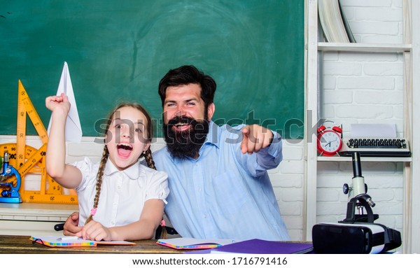 real happiness. knowledge day. Home schooling. small\
girl child with bearded teacher man in classroom. private lesson.\
back to school. Private teaching. daughter study with father.\
Teachers day.