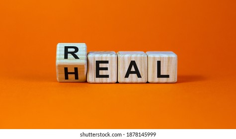 Real heal symbol. Fliped a wooden cube with words 'Real heal'. Beautiful orange background, copy space. Medical and real heal concept. - Shutterstock ID 1878145999