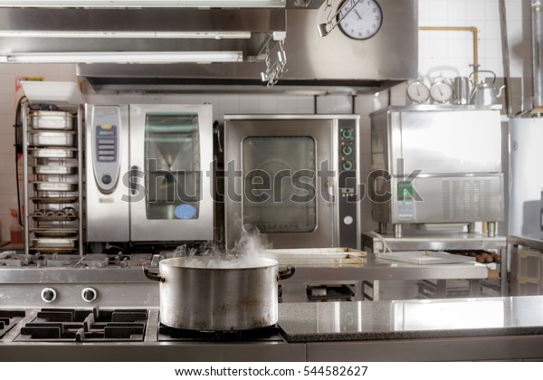 Real industrial kitchen pots in a professional\
restaurant kitchen