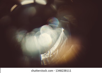 Real lens flare light effect on dark background. Sunlight refracted in glass. Can be used in your images to create various effects