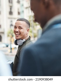 Real Life Young Man Portrait In The Street With Headphones, Enjoying Music On A Playlist App Looking Happy, Stressless And Cool. Normal Face Of A Millennial With Wireless Tech Outside An Urban City