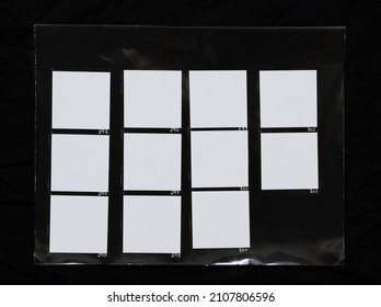 real macro photo of black and white hand copy contact sheet with 11 empty film frames. 120mm medium format film photo placeholder.	