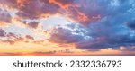 Real majestic sunrise sundown sky background with gentle colorful clouds without birds. Panoramic, big size