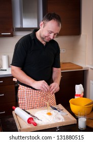 The real Man in the kitchen is making the cake to the dumplings - Shutterstock ID 131880515