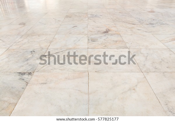 Real marble floor tile pattern new and clean\
condition for background, Symmetry grid line and space of marble\
texture in perspective view, Home interior decor with marble floor\
tile pattern luxury.