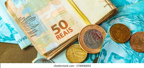 Real, Money From Brazil. Dinheiro, Brasil, Reais, Moedas. Real Banknote And Coins In Close-up.