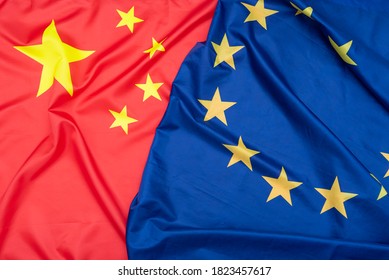 Real Natural Fabric Flag Of China Or National Flag Of The People's Republic Of China And EU European Union Flag As Texture Or Background