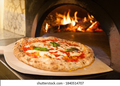 real Neapolitan Italian pizza called margherita pizza just out of the oven - Powered by Shutterstock