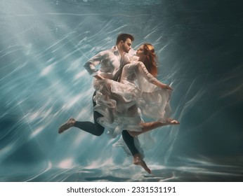 Real People art photo. Happy couple in love swim underwater, woman muse inspires male writer poet creator. Nymph girl dancing with guy at bottom sea under water. Red hair white long silk dress float. - Powered by Shutterstock